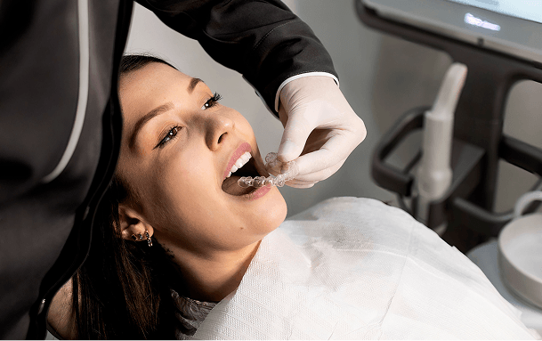 Patient being fitted with an Invisalign aligner