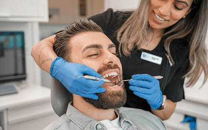 Dental nurse reassuring a patient in the chair