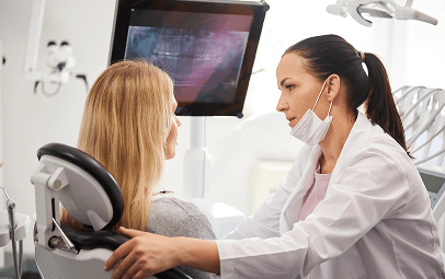 Hygienist talking with a patient before a clean